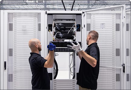Photo of CUDO engineers working in the data centre, representing the Run phase of CUDO's delivery process